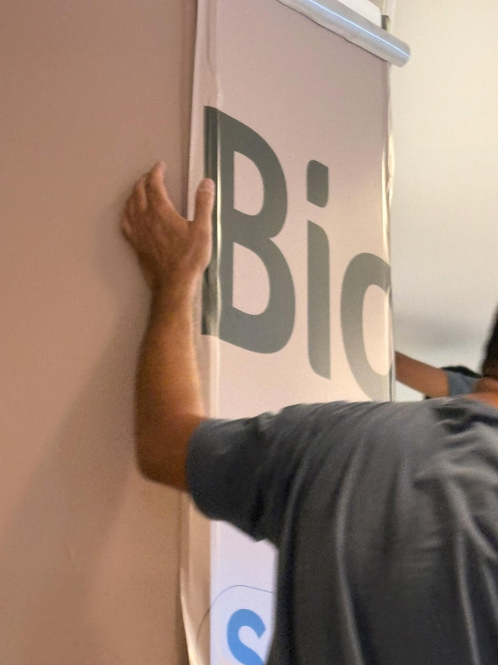 Aplicação do adesivo com o logo da Bio Mundo no tapume